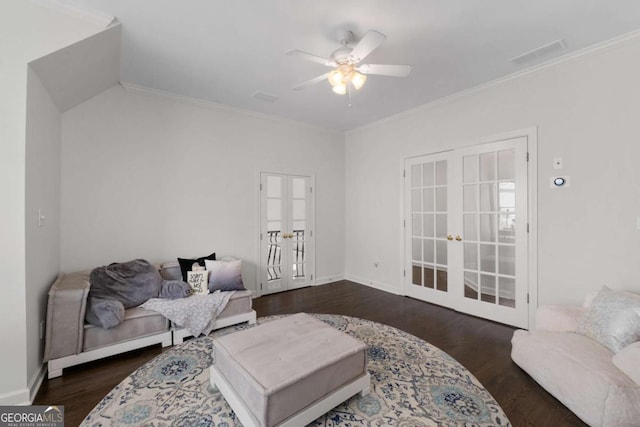 living area with french doors, ceiling fan, wood finished floors, ornamental molding, and baseboards
