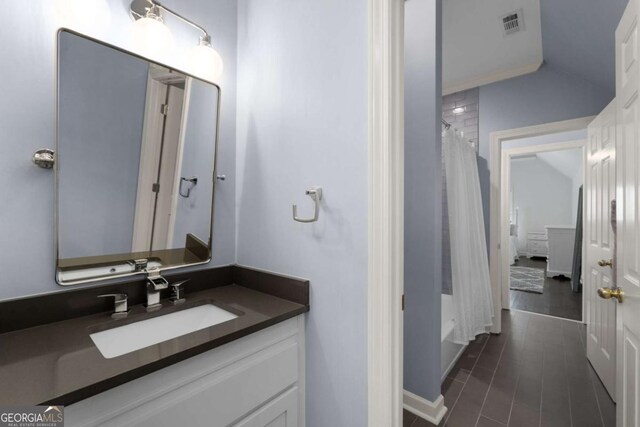 full bath with vanity, lofted ceiling, and shower / bath combo