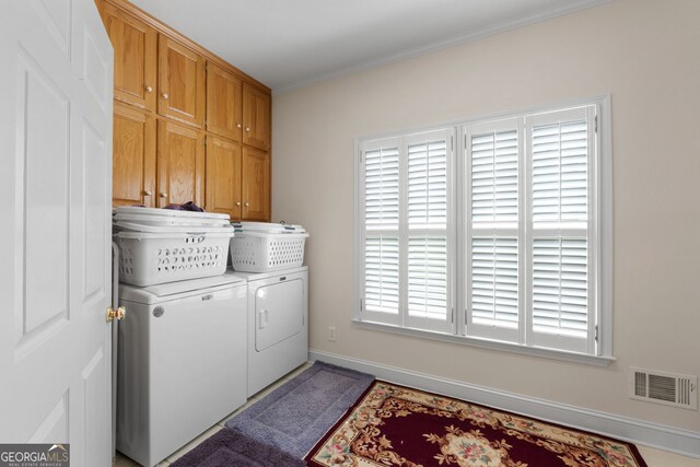 604 Clearwater Ct, Mcdonough, GA 30252 - laundry area featuring independent washer and dryer, cabinet space, and crown molding