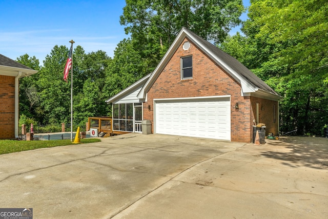 604 Clearwater Ct, Mcdonough, GA 30252 - view of side of home featuring brick siding, a garage, and view of wooded area