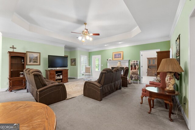 604 Clearwater Ct, Mcdonough, GA 30252 - living room with a raised ceiling, light colored carpet, a ceiling fan, and ornamental molding
