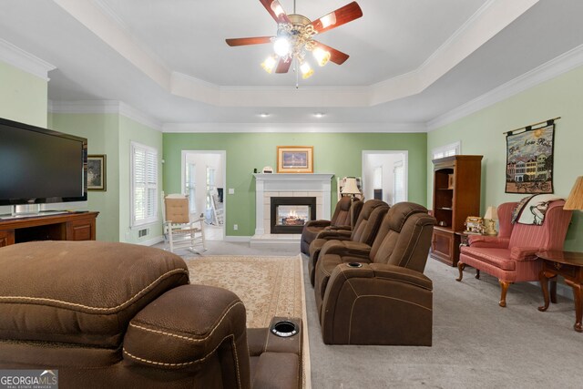 604 Clearwater Ct, Mcdonough, GA 30252 - living area featuring carpet, a raised ceiling, a fireplace, ceiling fan, and crown molding