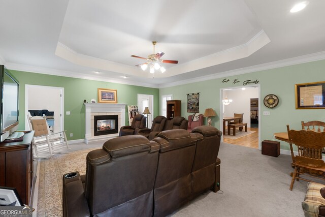 604 Clearwater Ct, Mcdonough, GA 30252 - living room featuring ornamental molding, a raised ceiling, ceiling fan, a tile fireplace, and light colored carpet