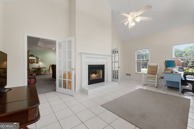 604 Clearwater Ct, Mcdonough, GA 30252 - home office featuring high vaulted ceiling, a ceiling fan, a tile fireplace, light tile patterned flooring, and french doors