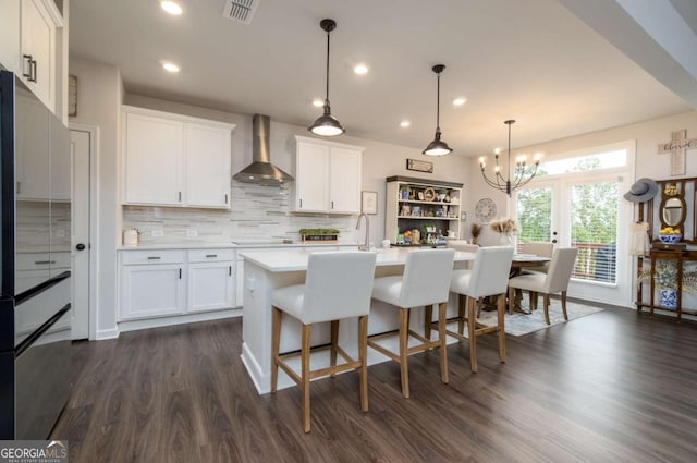 17 Ridgeline Way NW, Cartersville, GA 30121 - kitchen featuring wall chimney exhaust hood, light countertops, white cabinetry, backsplash, and a chandelier