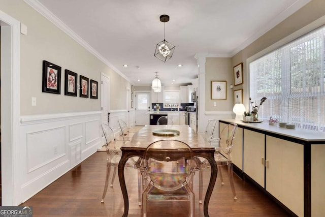 47 Roseclair Dr SE, Atlanta, GA 30317 - dining area featuring wood finished floors, crown molding, a decorative wall, wainscoting, and ornate columns