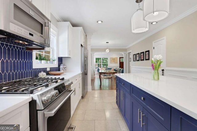 47 Roseclair Dr SE, Atlanta, GA 30317 - kitchen with stainless steel appliances, blue cabinets, decorative columns, white cabinets, and crown molding