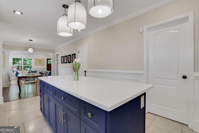 47 Roseclair Dr SE, Atlanta, GA 30317 - kitchen with ornate columns, blue cabinetry, light countertops, wainscoting, and ornamental molding