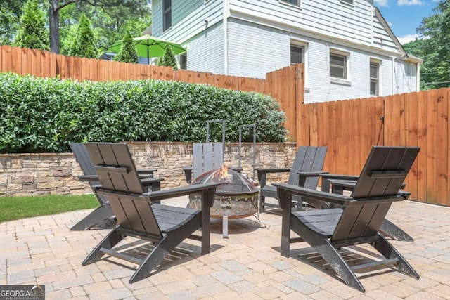 47 Roseclair Dr SE, Atlanta, GA 30317 - view of patio / terrace with an outdoor fire pit and a fenced backyard