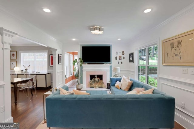 47 Roseclair Dr SE, Atlanta, GA 30317 - living area featuring decorative columns, a decorative wall, crown molding, dark wood finished floors, and a wainscoted wall