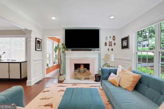 47 Roseclair Dr SE, Atlanta, GA 30317 - living area featuring wood finished floors, a fireplace with flush hearth, ornamental molding, and recessed lighting