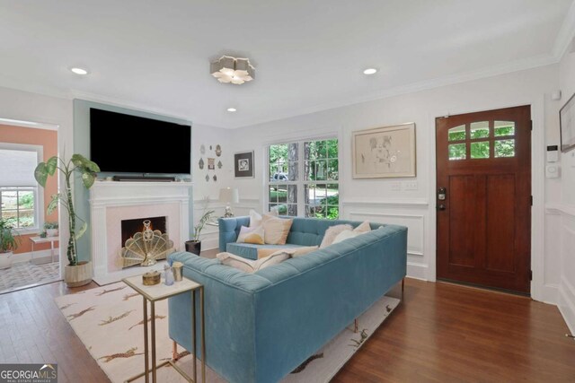 47 Roseclair Dr SE, Atlanta, GA 30317 - living room featuring healthy amount of natural light, dark wood-type flooring, a decorative wall, a fireplace, and wainscoting