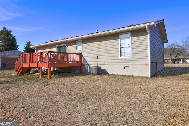 back of property with crawl space, a deck, fence, and central air condition unit