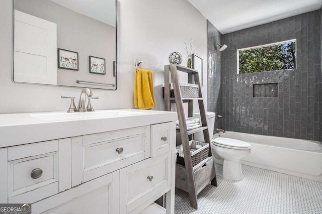 bathroom featuring vanity, toilet, tile patterned flooring, and shower / washtub combination