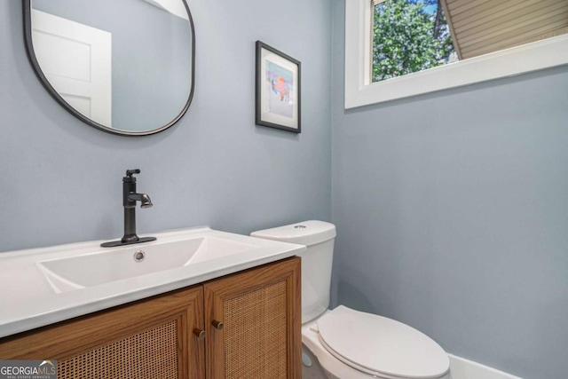bathroom with toilet and vanity