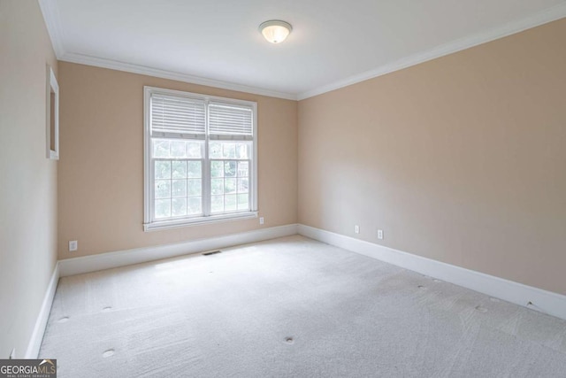 unfurnished room featuring carpet floors, ornamental molding, and baseboards