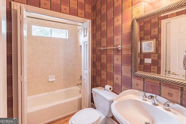 full bath with a sink, toilet, and shower / tub combination
