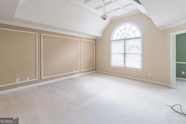 carpeted spare room with vaulted ceiling, baseboards, and crown molding