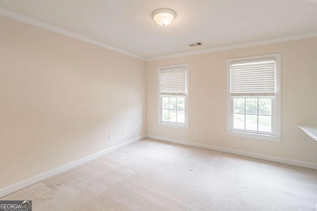 unfurnished room featuring ornamental molding, baseboards, plenty of natural light, and light carpet