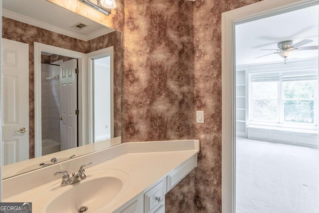 bathroom with vanity, wallpapered walls, ornamental molding, and a ceiling fan