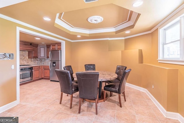 dining space with light tile patterned flooring, crown molding, a raised ceiling, recessed lighting, and baseboards