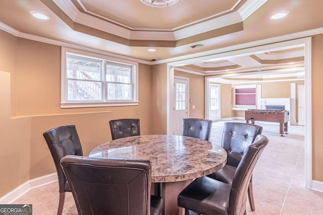 dining space with light tile patterned flooring, a tray ceiling, ornamental molding, recessed lighting, and baseboards
