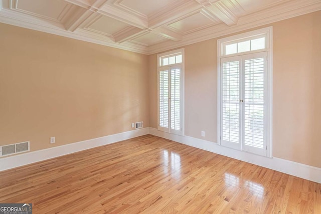 unfurnished room featuring baseboards, coffered ceiling, light wood-style flooring, crown molding, and beam ceiling