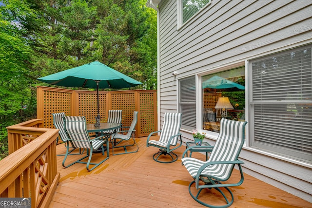 wooden terrace featuring outdoor dining area