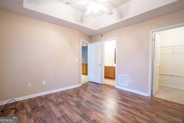 4015 Hidden Hollow Dr, Gainesville, GA 30506 - unfurnished bedroom featuring wood finished floors, baseboards, a walk in closet, a closet, and ensuite bath