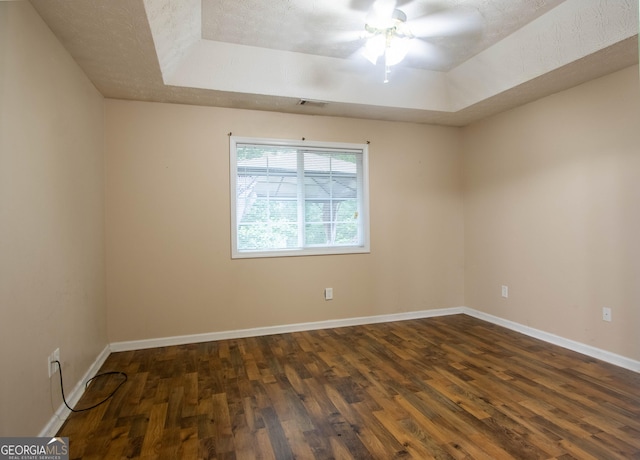 4015 Hidden Hollow Dr, Gainesville, GA 30506 - empty room with a tray ceiling, dark wood-style floors, a ceiling fan, and baseboards
