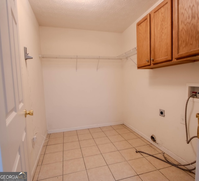 4015 Hidden Hollow Dr, Gainesville, GA 30506 - laundry room featuring cabinet space, hookup for an electric dryer, washer hookup, a textured ceiling, and baseboards