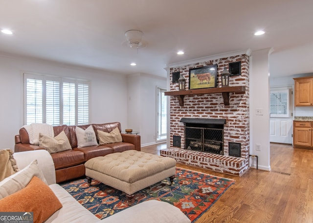 375 Luther Bailey Rd, Senoia, GA 30276 - living area featuring ornamental molding, a brick fireplace, light wood-type flooring, recessed lighting, and baseboards