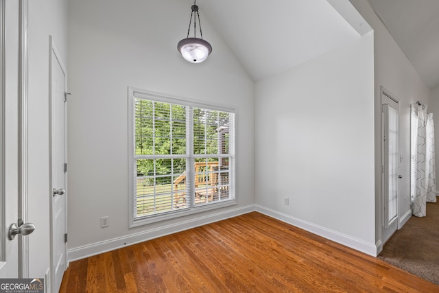 924 Vinings Dr, Winder, GA 30680 - unfurnished bedroom with baseboards, lofted ceiling, and wood finished floors