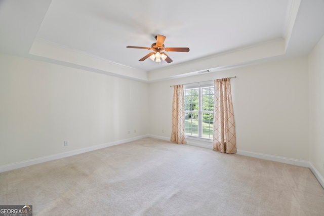 924 Vinings Dr, Winder, GA 30680 - carpeted spare room featuring a tray ceiling, a ceiling fan, baseboards, and crown molding