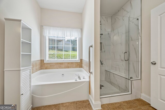 924 Vinings Dr, Winder, GA 30680 - full bathroom featuring a bath, a shower stall, and tile patterned floors