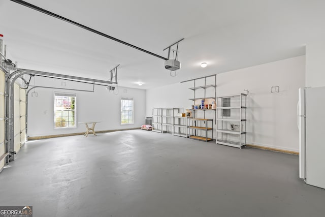 924 Vinings Dr, Winder, GA 30680 - garage with freestanding refrigerator and a garage door opener