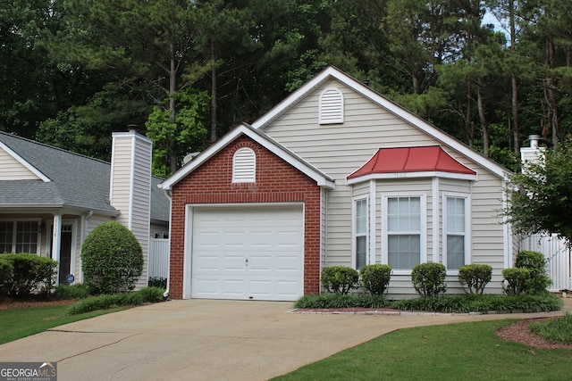 view of front of property with concrete driveway, brick siding, and a garage