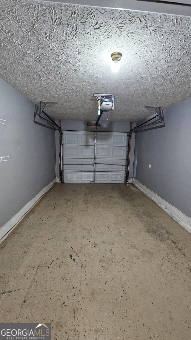garage featuring baseboards and a garage door opener