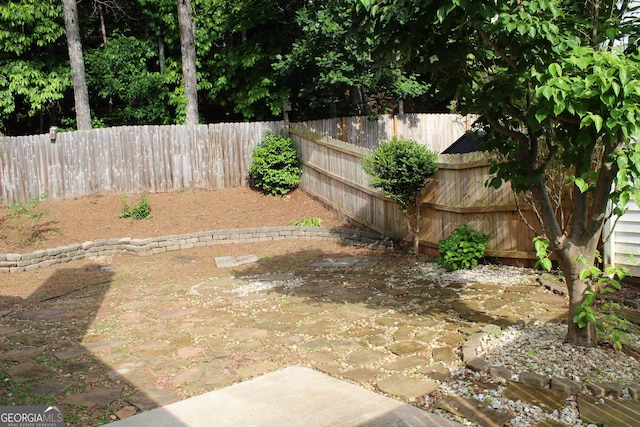 fenced backyard with a patio area
