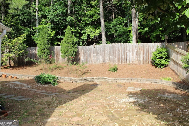 fenced backyard with a patio area