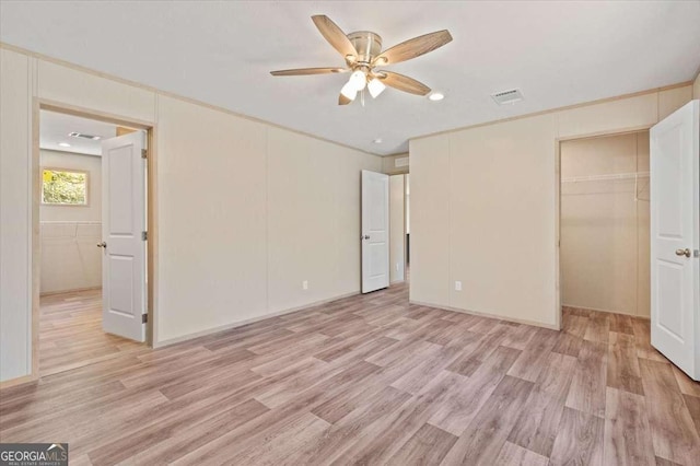 unfurnished bedroom featuring light wood-style floors, ceiling fan, and a closet