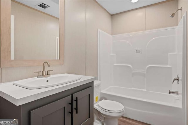 full bath with toilet, tub / shower combination, vanity, and wood finished floors