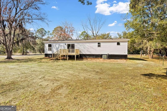 rear view of house with a wooden deck, a lawn, and central air condition unit