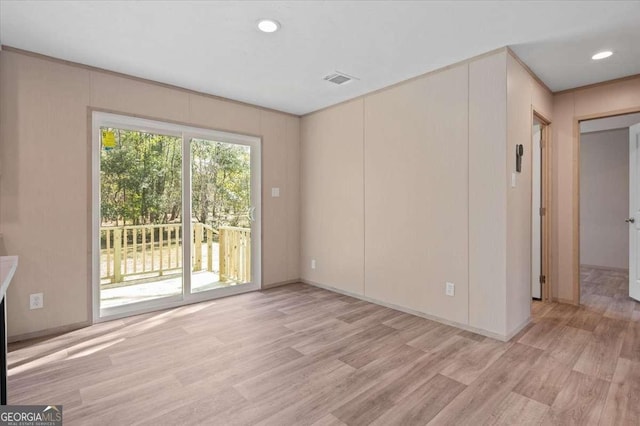 empty room with light wood-type flooring and recessed lighting