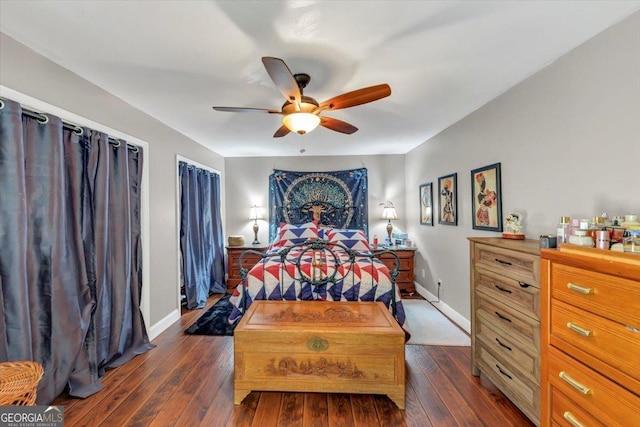 bedroom featuring dark wood finished floors, ceiling fan, and baseboards