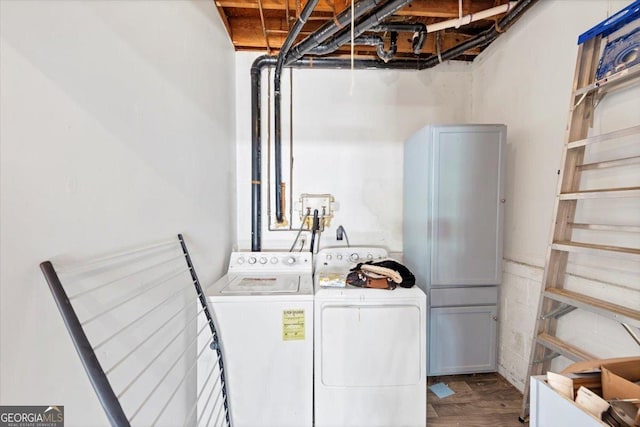 laundry area with separate washer and dryer and wood finished floors