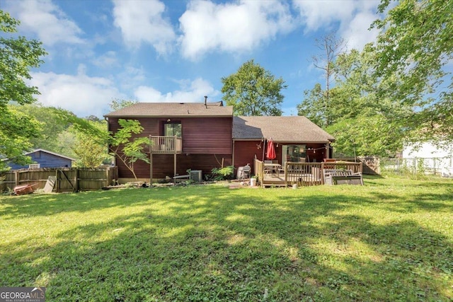 back of property featuring a deck and roof with shingles