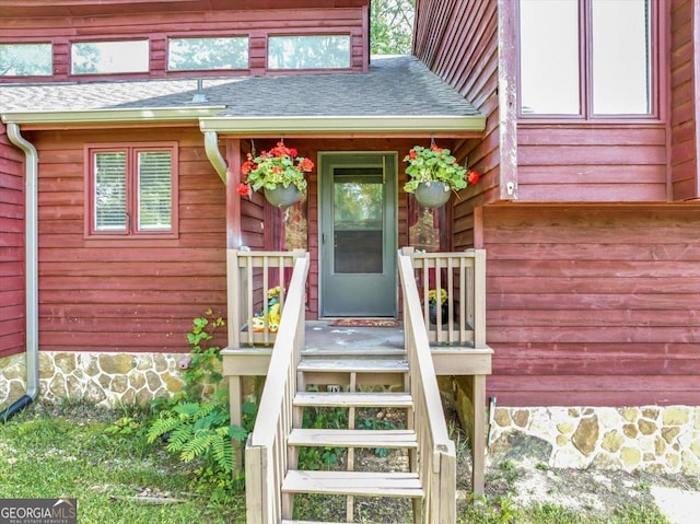 property entrance with roof with shingles