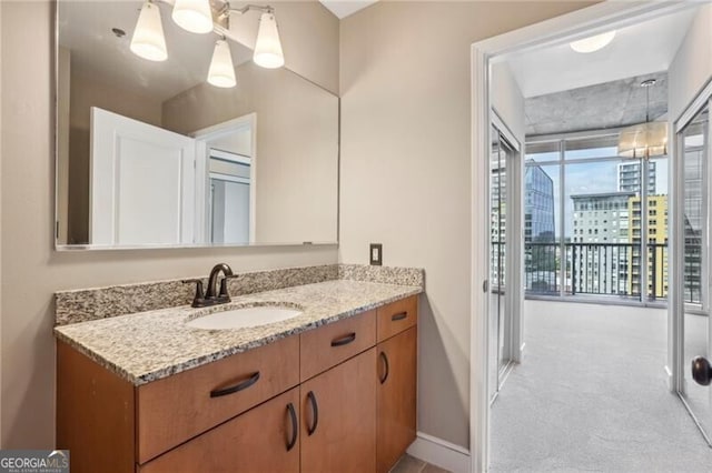950 W Peachtree St NW Unit 1613, Atlanta, GA 30309 - bathroom with vanity, baseboards, and a city view
