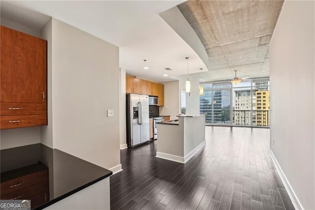 950 W Peachtree St NW Unit 1613, Atlanta, GA 30309 - kitchen with appliances with stainless steel finishes, dark wood-style flooring, baseboards, and pendant lighting